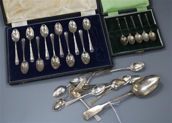 Two incomplete cased sets of silver teaspoons, eleven other silver teaspoons and a Georgian silver tablespoon.